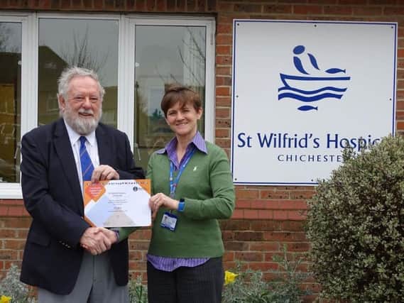 Rodney Chambers from the Sussex Masonic Charities presents St Wilfrids Hospice with a certificate from the Masonic Charitable foundation