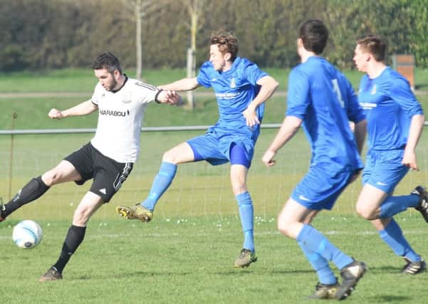 Bexhill United forward David Pugh is closed down by the Selsey defence. Picture courtesy Jon Smalldon