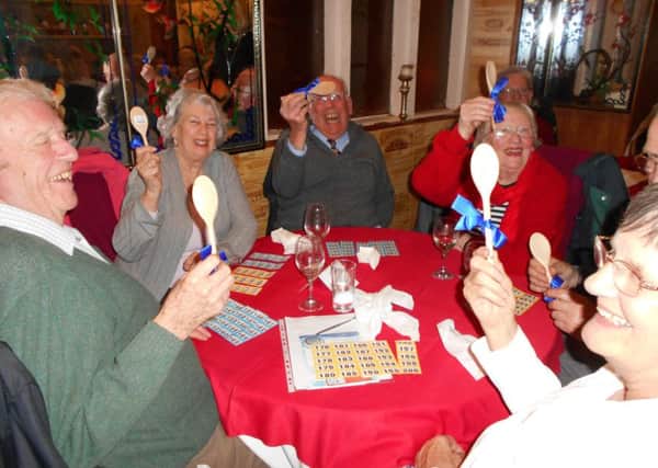 Stirring it up - The Hastings Conquerors. with their wooden spoons;  prizes for being last in the Sara Lee Trust Quiz and Curry evening SUS-170321-154050001