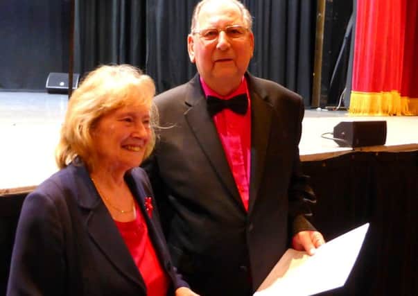 Hastings International Musical Festival adjudicator Valerie Hoppe presents musical director of the Treble Clefs choir, Keith Richardson with a Special Merit certificate. SUS-170321-140611001