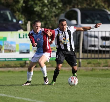 Harry Stannard tussles for possession during Hastings United's game at home to Tooting & Mitcham United last weekend. Picture courtesy Scott White