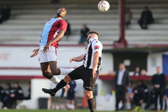 Shomari Barnwell goes up for a header against Tooting & Mitcham United. Picture courtesy Scott White