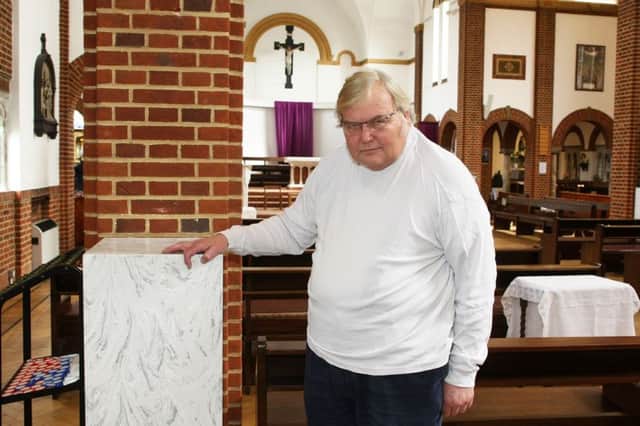 DM17312955a.jpg. Father Martin Jakubas in St Paul's church, Haywards Heath, beside where a statue of St Therese of Lisieu was ripped from the wall and smashed to pieces. Photo by Derek Martin SUS-170317-191230008