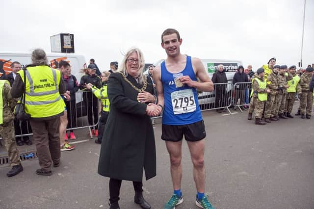 Rhys Boorman is congratulated by Hastings Mayor, Cllr Judy Rogers, after finishing second in the 2017 Hastings Half Marathon. Picture courtesy Frank Copper