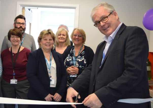 Michael Wilson CBE chief executive cutting the ribbon and officially opening the new SASH Occupational Health Department located at East Surrey Hospital (photo submitted).