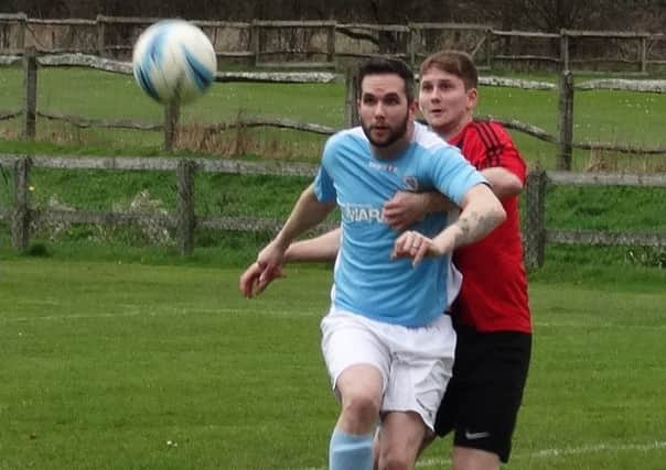 Bexhill United forward David Pugh holds off a Billingshurst opponent. Pictures courtesy Mark Killy