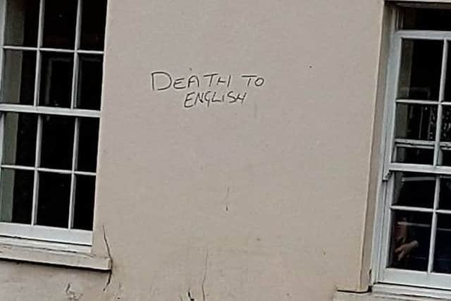 The graffiti outside flats in the Hornet left in black marker, taken on Wednesday morning, March 22. Similar graffiti is understood to have been written outside the flats on Wednesday night, after the terror attack