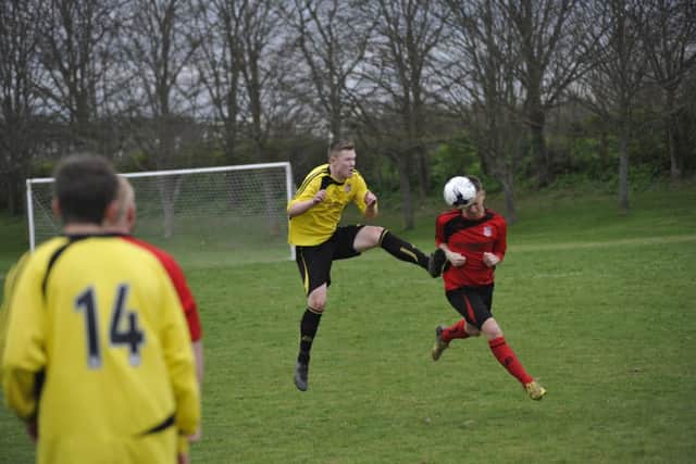 Luke Willis in the thick of the action against Icklesham Casuals.