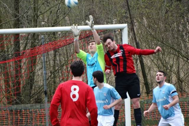 Bexhill United goalkeeper Dan Rose challenges for a high ball against Billingshurst. Picture courtesy Mark Killy