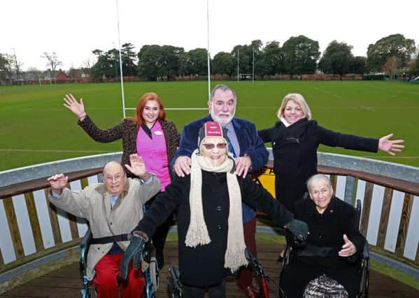 New accessibility facilities at Chichester Rugby Club have been completed and residents from Colten Care's Wellington Grange care home joined sponsorship manager Ron Migliorini on the balcony for a great view of the pitch. Resident Josie Allman (centre) tried on some rugby headgear and is pictured with fellow residents Paul Harvey and Bunny Storrar, activities organiser Emily Hudson, Ron Migliorini and home manager Clare Gibson