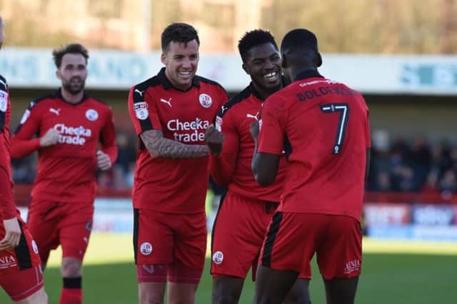 Crawley Town's Andre Blackman congratulates Enzio Boldewijn for scoring Reds' third goal against Leyton Orient.
Picture by PW Sporting Photography