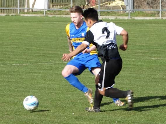 Bexhill United wide player Corey Wheeler in the thick of the action. Picture courtesy Mark Killy
