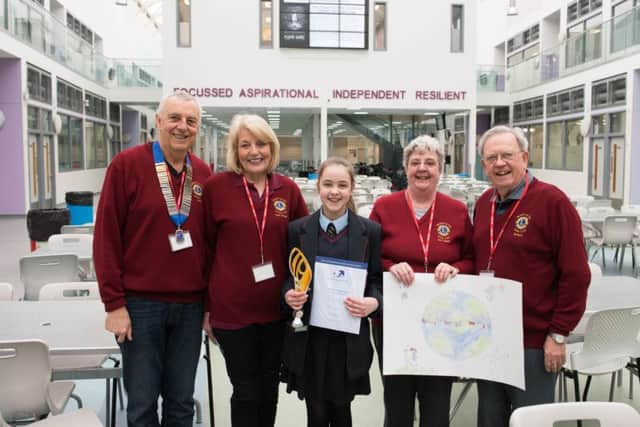 Bexhill Lions Club members present Peace Poster competition winner Moe Murphy with a trophy and certificate. SUS-170328-105621001