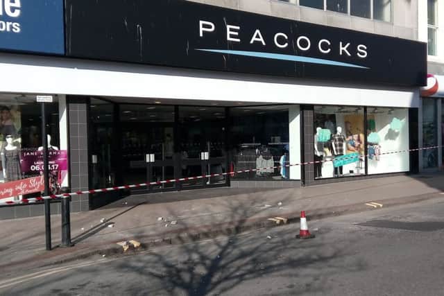 Sussex Police has closed the road after masonry fell from the front of Peacocks, in Chapel Road, Worthing. Picture: Michael Drummond SUS-170328-095106001