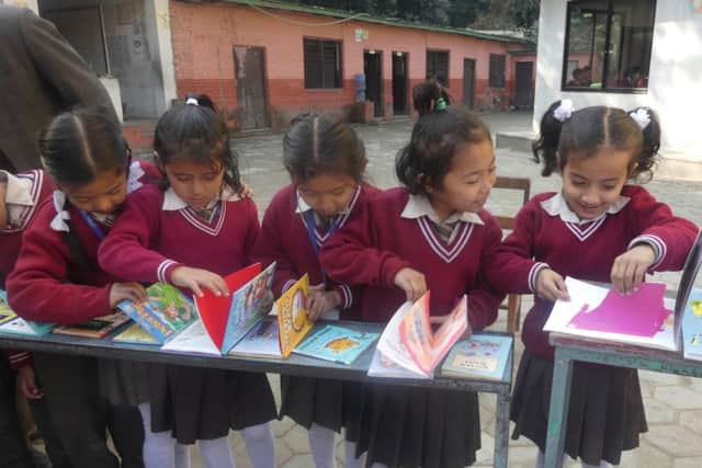 The books have been provided to help the children learn English. Picture: Tony Parris