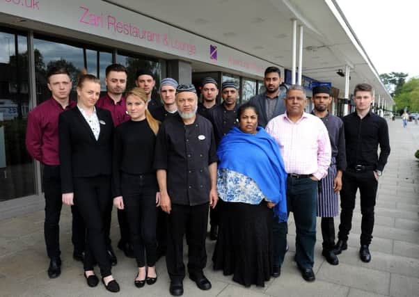 Almara and Sadique Miah and staff outside the Zari Restaurant and Lounge in Ifield Parade. Picture: Steve Robards
