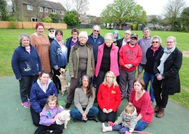 Residents, including Kerry Allen (bottom right), gathered at the site where the play equipment used to be. Picture: Kate Shemilt