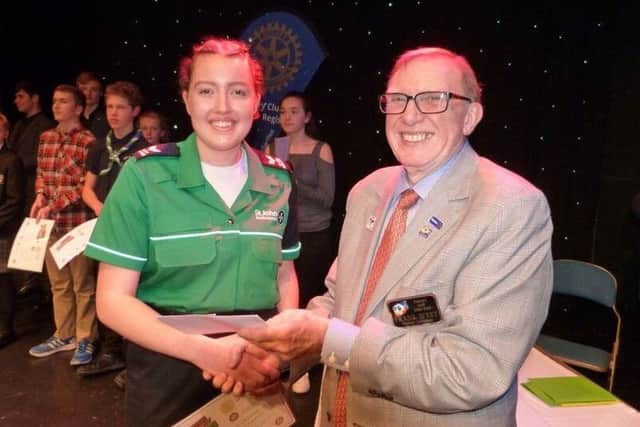 Rotary district governor Frank West presents a certificate to St John Ambulance cadets, group winners