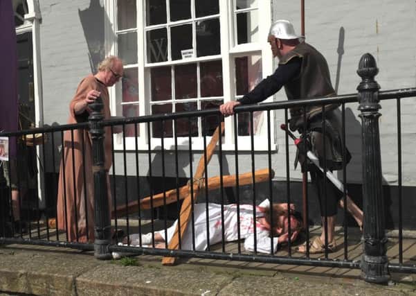 An arm of the cross used in the re-enactment went through the window at a house in the High Street. Picture by James Taylor (jamesrtayloruk@gmail.com)