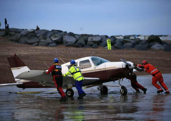 The plane is moved from the sea following the crash. Picture: Eddie Mitchell