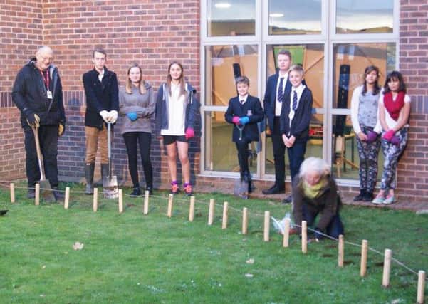Students helping to plant bulbs in November with Mary and Bob Pavard from Bognor Rotary Club