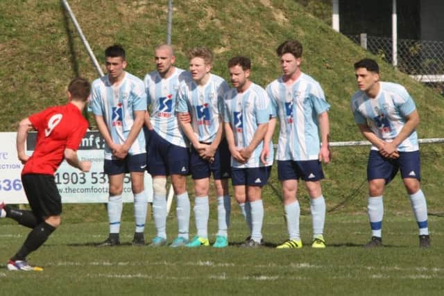 Worthing United line up for a free kick against AFC Uckfield.
