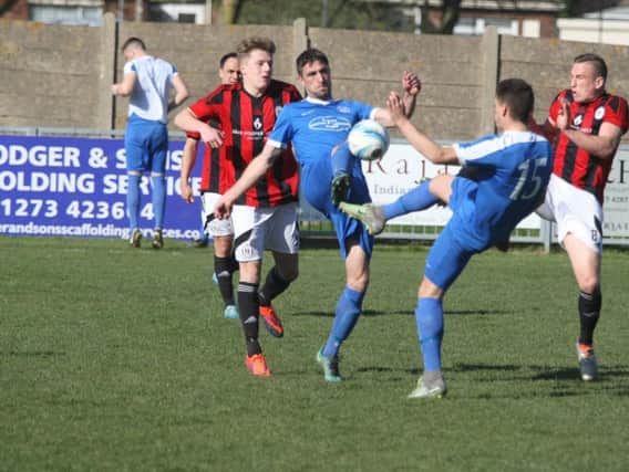 Players from both teams battle for possession during Saturdays top-of-the-table clash. Picture by Derek Martin
