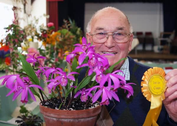 Norman Allcorn with his exhibit, which one best in show in the flower categories. Pictures: Derek Martin dm17417798a