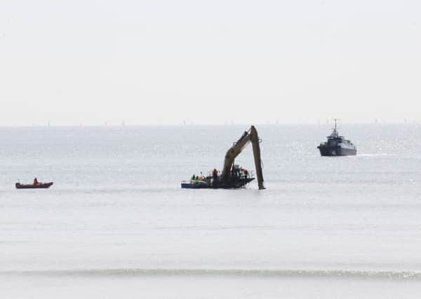 The digger was spotted off the coast of Worthing beach yesterday. Pictures: Eddie Mitchell