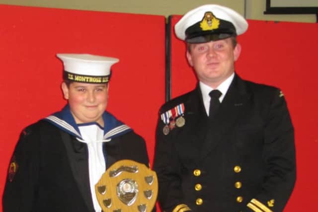 James Price is presented with best dress and turn out by commanding officer Paul Nicholls