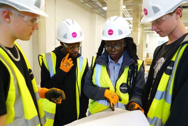 Osborne trainee site manager Janet Osei-Berchie, showing students from the Greater Brighton Metropolitan College round Sussexs new Â£9m Construction and Trades Training Centre. (students, from left: Caius Scott Hughes, Nicky Chingoma, Alfie Barker) (Photograph: METfutures/Bosie Vincent) SUS-170304-155218001