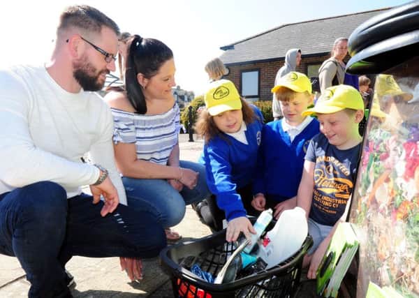 Tangmere Primary School pupils Alfiie Harding, nine, Callum Chatfield, ten, and Nicole Dobrucka, ten, chatting to visitors Tim and Laura White about their recycling scheme. Pictures: Kate Shemilt ks170823-1
