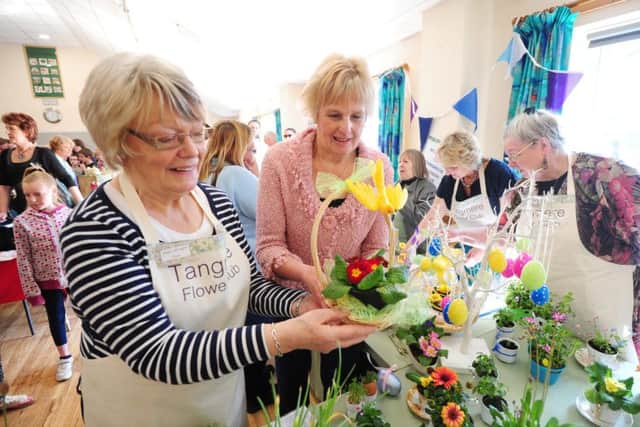Tangmere Flower Club chairman Jean Wright with Sue Wyatt, looking at the Easter flower baskets ks170823-3