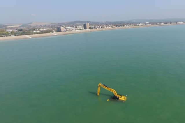 The partially-submerged digger off the coast of Worthing beach, captured by a Phantom drone. Picture: Whitey