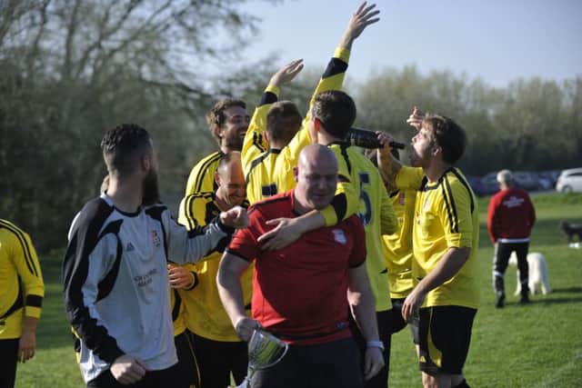 Rye Town celebrate after receiving the Macron East Sussex Football League Division One trophy.