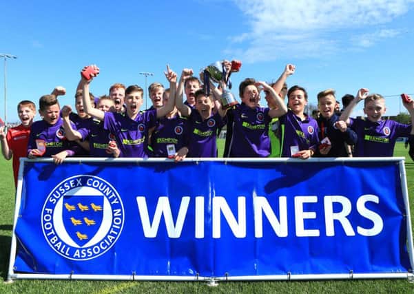 Barnham Trojans under-13s lift the cup / Picture by Simon Roe