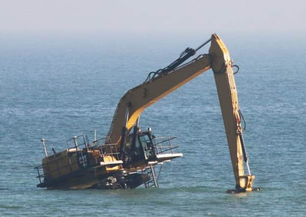 The 80-tonne digger has been stuck in the sea since Tuesday. Picture: Eddie Mitchell