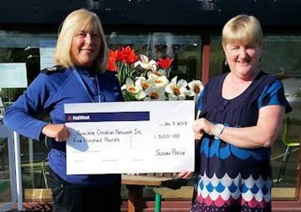 Caroline McConnell presents cheque to Reverend Lynda Hulcoop