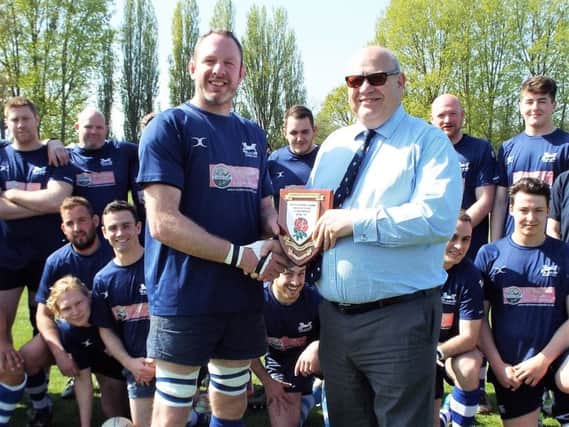 Hastings & Bexhill Rugby Club captain Jimmy Adams receives the Kent One winners' shield. Picture courtesy Peter Knight