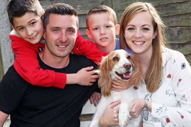 Rueben the spaniel with owners Matt and Stacie Lillywhite and their children Finley and Harrison. Picture: Derek Martin