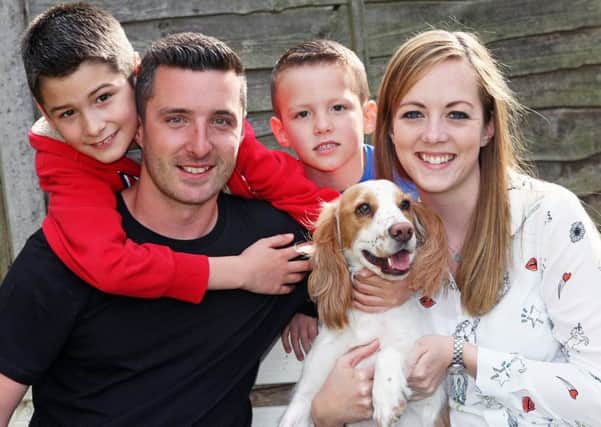 Rueben the spaniel with owners Matt and Stacie Lillywhite and their children Finley and Harrison. Picture: Derek Martin