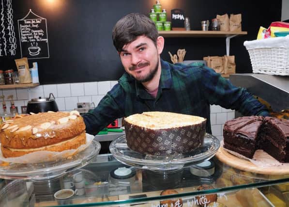 Waterstones Community CafÃ© manager Roland Squire with some cakes which were made locally by students at Autism Sussex on Roebuck Street, Hastings. SUS-170304-144326001