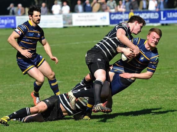 Gabriel Dobson feels the full force of a Chinnor challenge on Saturday. Picture by Stephen Goodger