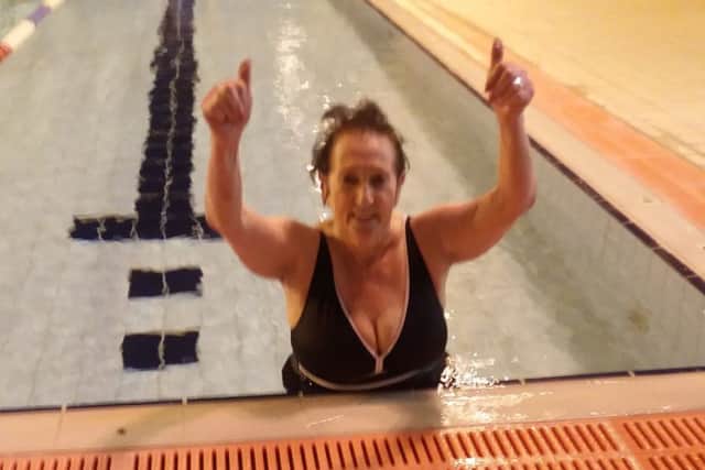 Ann Lizzimore celebrating after completing the Swimathon