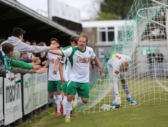 James Fraser leads the players in celebration after scoring from the spot / Picture by Tim Hale