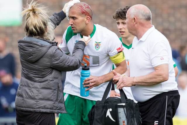 Sami El-Abd is treated after sustaining a gashed forehead / Picture by Tim Hale