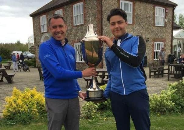 Rohan Miah receives the junior open trophy from Mark Wood
