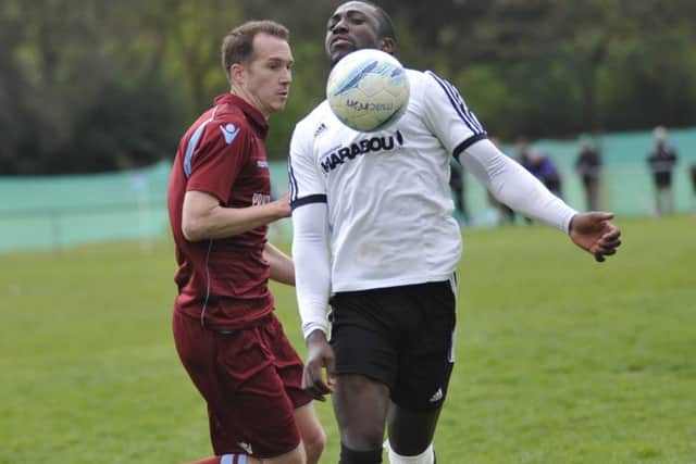 Bexhill United midfielder Georges Gouet chests the ball down with Little Common forward Lewis Hole in close attendance.