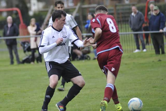 Little Common midfielder Bradley Pritchard tries to escape the attentions of Bexhill United full-back Craig Ottley.