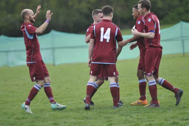 Little Common celebrate their second goal.